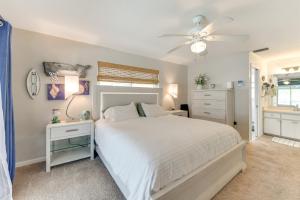 a bedroom with a bed and a ceiling fan at Fish, Swim and Relax Canal-Front Port Charlotte Gem in Port Charlotte +17 photos