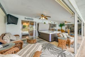 a living room with a tub and tables and chairs at Fish, Swim and Relax Canal-Front Port Charlotte Gem in Port Charlotte