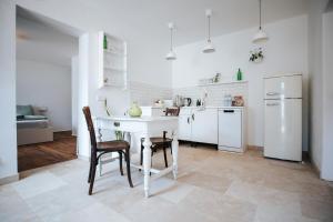 a kitchen with a white table and a white refrigerator at Auszeit in Halbturn in Halbturn