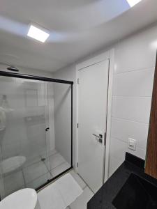 a bathroom with a glass shower and a toilet at zyz centro in Sao Paulo