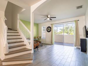 a staircase in a home with a ceiling fan at Luxury & Comfy Family Gem near Disney with Pool andGym in Kissimmee