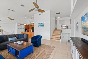 a living room with a couch and a table at Private Bayfront Beach House with Dock, Steps to Beach and Restaurants in Englewood