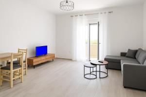 a living room with a couch and a table at Miltons House in Vlorë