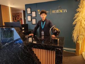 a man standing at a counter in a store at Herencia Hotel by Dream Vacation in Pasto +29 photos