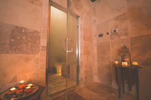 a shower with a glass door in a bathroom at Le Mas Du Batadou in Visan