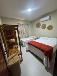 a hotel room with two beds and a window at Chalé Betel Santo Amaro in Santo Amaro +22 photos
