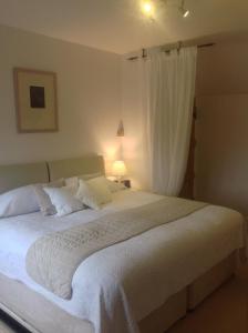 a bedroom with a large white bed with a window at Shakespeare's View in Stratford-upon-Avon +23 photos