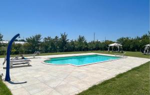 a swimming pool in the middle of a yard at Stunning Apartment In Manciano in Poderi Rancoli +13 photos
