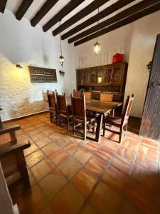 a dining room with a wooden table and chairs at Casa de Piedra in Cedro