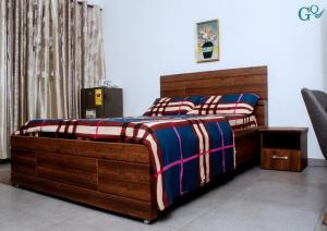a bedroom with two twin beds and a chair at Plsa 5bedroom house at east legon in Accra