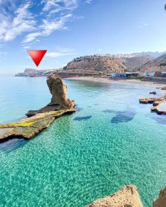 a red triangle flying over a body of water at Appartement à louer Al Hoceima vue mer in Al Hoceïma +12 photos