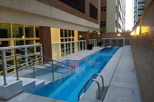 a swimming pool on the side of a building at Flat Estanconfor Santos na Quadra da Praia com Vista do Mar in Santos +22 photos