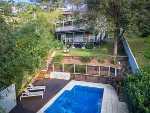 an aerial view of a house with a swimming pool at Cottage on Riv - Winter Holiday Mid-Week Special in Terrigal