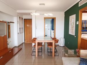 a dining room with a table and some chairs at Valencia Playa Patacona Resort in Valencia