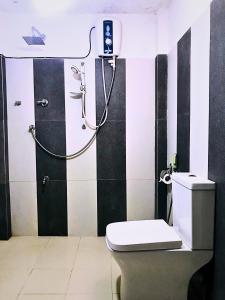 a bathroom with a shower and a toilet in it at The European Gate - Anuradhapura in Anuradhapura +95 photos