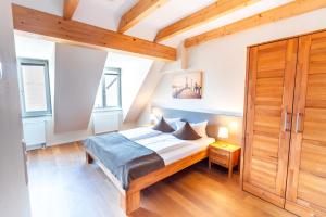 a bedroom with a bed and a wooden door at Gasthaus Adler Konstanz in Konstanz