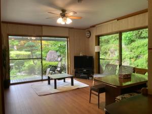 a living room with a couch and a table at Monet House モネハウス in Shimo-horado