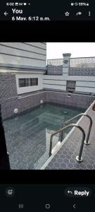 une photo d'une piscine en face d'une maison dans l'établissement Deluxe Apartment Room #12, à Ikeja