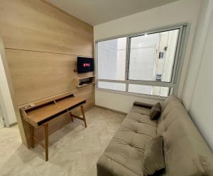 a living room with a couch and a window at LK Centro 8 in Belo Horizonte