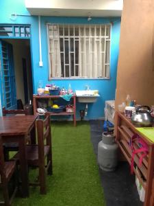 a room with a table and a sink and a table and a room with at Hospedaje TUTUMEME in Churín +28 photos