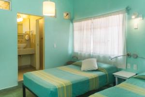Postel nebo postele na pokoji v ubytování Casa de Don Pablo Hostel