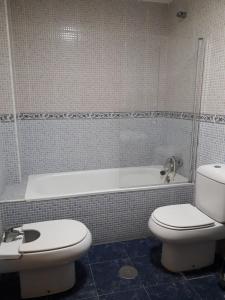 a bathroom with a toilet and a bath tub at Apartamento Turístico Céntrico Galper in Melilla