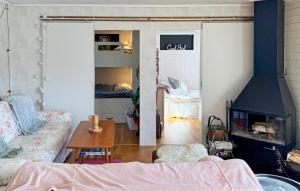 a living room with a couch and a fireplace at Amazing Home In Motala With Wifi in Motala