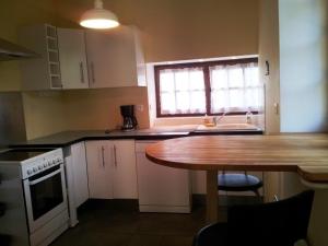 a kitchen with a table and a sink and a window at Charmante grange rénovée avec vue proche de Moulins - FR-1-489-576 in Bressolles