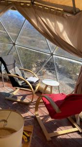 a room with chairs and a table and a window at Terrana Ecolodge Mountain Domes in Ciudad Lujan de Cuyo