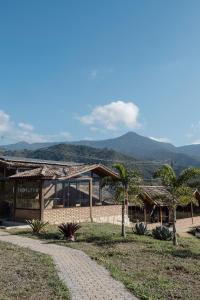 a building with palm trees in front of it at Idilicos Mauá in Visconde De Maua +38 photos