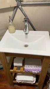 a white sink with towels on a shelf under it at Terrana Ecolodge Mountain Domes in Ciudad Lujan de Cuyo +15 photos