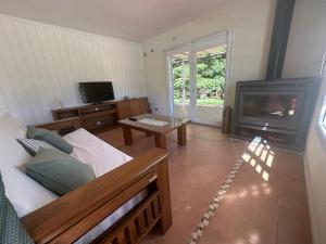 a living room with a couch and a fireplace at La Colorada Dolores in Dolores