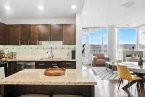 a kitchen and living room with a table and chairs at 17th Avenue Paranomas Escape in Calgary