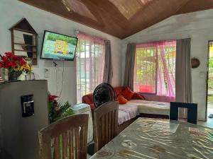 a living room with a table and a couch at Tortuguero Family House in Colorado