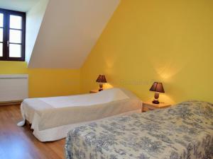 two beds in a room with yellow walls at Charmant Gîte Familial proche du Lac de Chemillé-sur-Indrois, 3 Ch, Jardin, Activités, Châteaux. - FR-1-381-375 in Chemillé-sur-Indrois