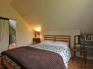 a bedroom with a bed in a room with a window at Maison en pierres avec Grand Jardin, WIFI, tout inclus - FR-1-497-170 in Neuvy-au-Houlme