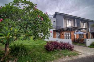 a house with a tree in front of it at Casa de Lily in Tabanan