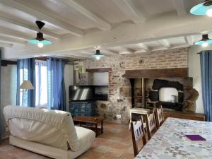a living room with a white couch and a table at Gîte indépendant à Saint-Genest avec jardin clos - FR-1-489-562 in Saint-Genest