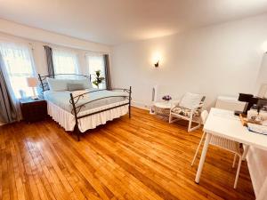 a bedroom with a bed and a wooden floor at Prime and Precious location The Red House Room3 in Charlottetown
