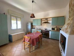 a kitchen with blue cabinets and a table with chairs at Dream Home in Nardò +29 photos