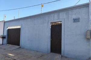 a gray building with two doors and a sign on it at Aluguel por Temporada Marabá in Marabá