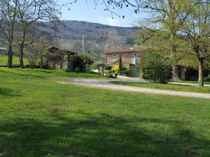 a house in a field with a dirt road at Gîte de charme avec piscine privée, terrasse et cour close à Saint-Appolinard - FR-1-496-202 in Saint-Appolinard