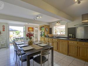 a kitchen with a table and some chairs in a room at Gîte de charme avec spa, sauna et jardin privatif à Montbrison - FR-1-496-309 in Montbrison