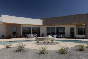 a house with a swimming pool in front of it at Orchid by Fieldtrip Architectural Estate w Pool, Spa, Game Room in Yucca Valley