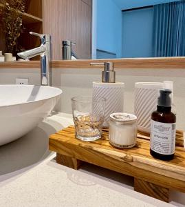 a bathroom with a sink and a wooden tray with a glass at Villa Mamakami - Private Luxury Rooms in Canggu in Canggu +42 photos