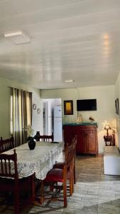 a dining room with a table with chairs and a refrigerator at Casa Don Tori Paso de la Patria in Paso de la Patria