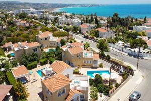 an aerial view of a residential neighborhood with houses and the ocean at Villa Camelia by Villa Plus in Peyia