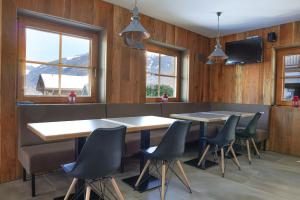 a restaurant with two tables and chairs and windows at Holiday home in Kaltenbach - Zillertal 868 in Kaltenbach