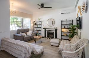a living room with a couch and a fireplace at Charming Malaga Retreat, Main House plus Cozy Casita in Málaga