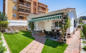 a patio with a table and chairs in a yard at Charming Malaga Retreat, Main House plus Cozy Casita in Málaga